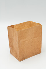 Brown paper bag on white background - 779697680
