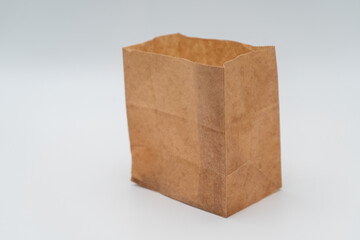 Brown paper bag on white background - 779697807