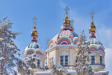 Domes of Ascension Cathedral in snow-covered in Panfilov Park, Almaty, Kazakhstan.