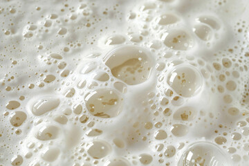 White fluffy fresh bath foam with bubbles texture close up detail background.