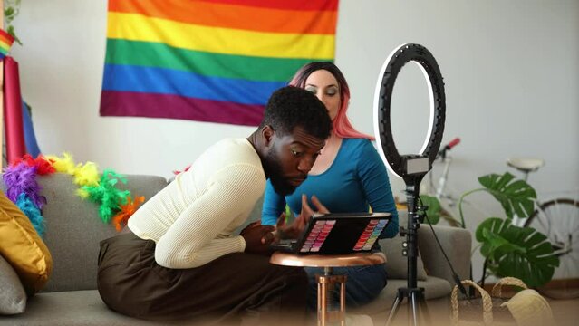 friends prepare and put on makeup for gay pride party