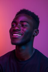Portrait of a young smiling African American man in neon light.