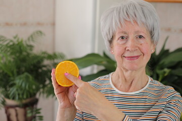 Senior woman showing the interior of a fruit 