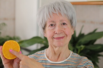 Senior woman showing the interior of a fruit 