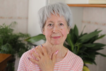 Senior woman with artsy multicolored long nails 