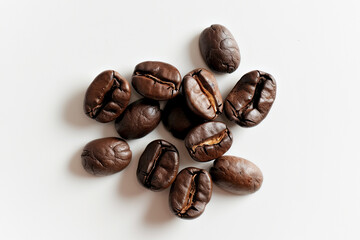 A Pile of Coffee Beans on a White Surface