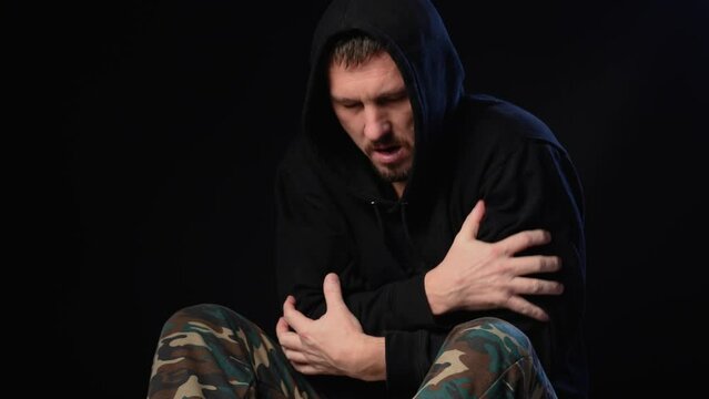 Man in severe physical or mental pain. Drug addiction and alcohol withdrawal concept.