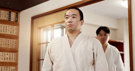 Aikido student, ready or men in dojo to start practice, discipline or self defense education in...