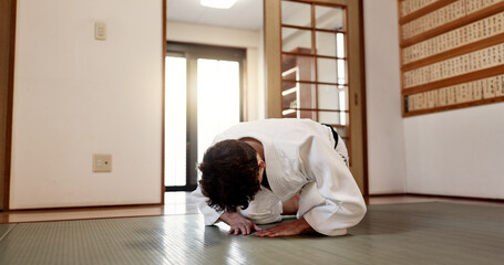 Aikido student, man or bow in dojo for training practice, discipline and black belt in class....