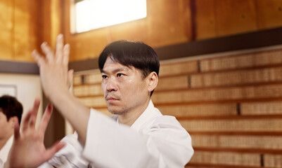 Japanese student, aikido or training martial arts in dojo for practice, fighting education or self...