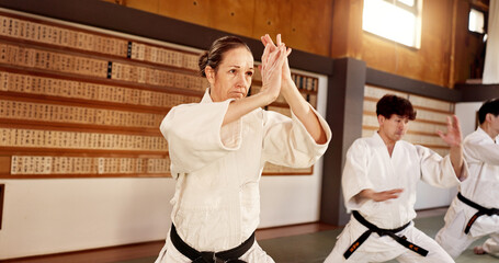 Aikido dojo, people and fight for martial arts, strike or together for combat at training, gym or class. Japanese students, group and sport for exercise, workout or fitness with zen, conflict or club