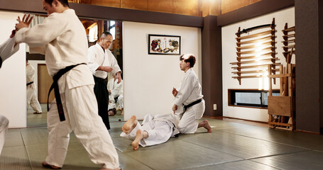 Japanese master, student or training in martial arts in dojo place, block or fighting in aikido in...