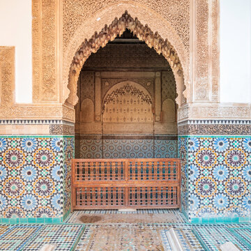 Very ornate, arabic archway, covered in carved wood and mosiac tiles. 