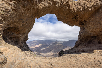 The rock formation Ventana del Bentayga (Window to Bentayga) with the peak Roque Bentayga behind, Grand Canary, Spain.