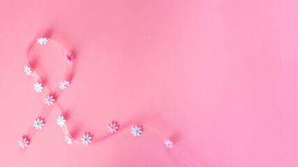 Breast Cancer. Pink ribbon, pink and white fabric flowers on a pink background. World cancer day, awareness concept