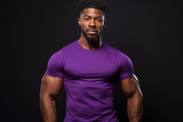 Fototapeta na wymiar Afro American fitness model in purple t-shirt with well defined muscles