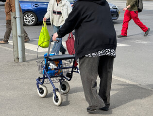 Senior woman with a walker on the street