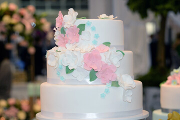 Wedding cake decoration with colorful flowers, it is served at wedding receptions. Vintage style for weddings, birthdays.
