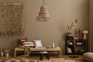 Stylish composition of boho ethno living room with daybed, blak shelf, pillows, decoration, beige...