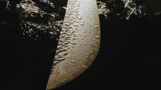 Drops of water on the blade of an expensive exclusive kitchen knife.