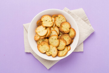 Spiced bruschette chips on color background, top view