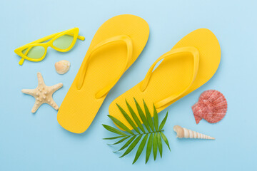 Bright yellow flip-flops on color background, top view. Summer concept