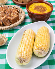 Typical brazilian june festival food over plaid fabric. Festa junina