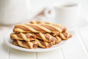 Classic Striped Cookies on plate on white table.