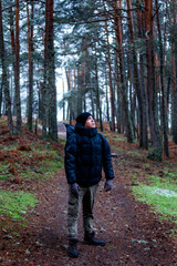 Portrait of a Latino man with mountain gear, embracing snowy Guadarrama scenery.