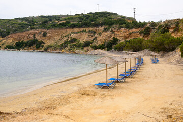 Sun loungers on sandy Limnionas beach. Kos island, Dodecanese, Greece