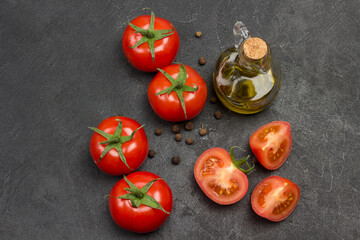 Whole tomato and chopped tomato wedges, allspice on table. - obrazy, fototapety, plakaty