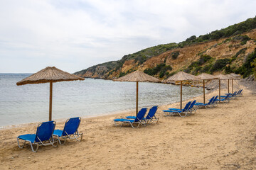 Sun loungers on sandy Limnionas beach. Kos island, Dodecanese, Greece