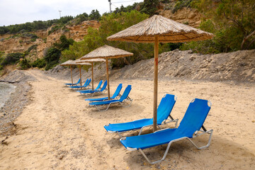 Sun loungers on sandy Limnionas beach. Kos island, Dodecanese, Greece