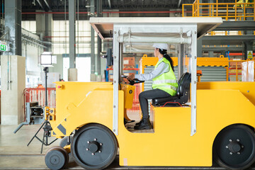 Warehouse Worker Operating Electric Tugger