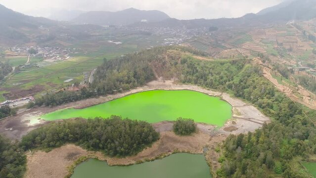 volcanic sulfur lake telaga warna in dieng plateau, java Indonesia. mountain tropical landscape lake with green water among mountains. this lake is one mainstay tourist destinations in Wonosobo