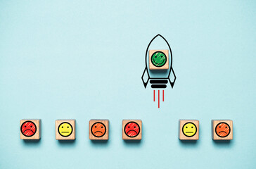 Smile face icon inside rocket missile rising from sad face icon for customer excellent experience evaluation feedback and survey after use product and service concept.