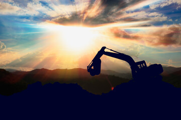 Crawler excavators silhouette are digging the soil in the construction site. on  sunlight background - obrazy, fototapety, plakaty