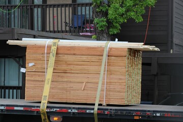 A pallet of plywood arrives at a job site where a large scale roofing project was underway.