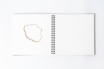 White open notebook with burnt page. The blank layout template of the spiral notebook on white background.