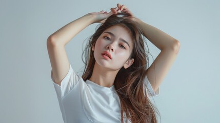 Fototapeta premium Portrait photo of a model wearing a white t-shirt against a white background with professional lighting in a studio.