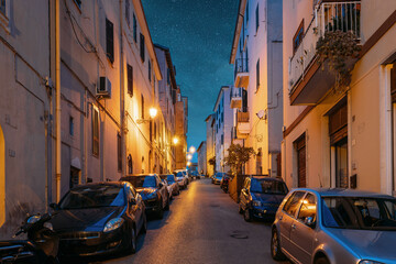 Cars Parked On Narrow Street In European City In Summer Night.