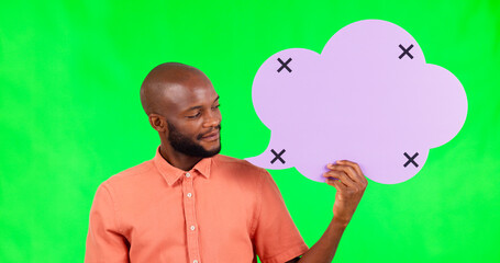 Speech bubble, space and a black man on green screen in studio for social media communication. Portrait, marketing or advertising and a male brand ambassador holding mock up with tracking markers