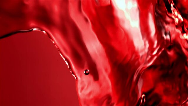 Super slow motion of the rocket of pomegranate juice pours. Filmed on a high-speed camera at 1000 fps. High quality FullHD footage