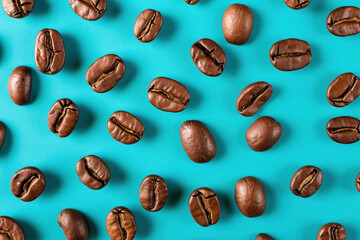 Freshly Roasted Coffee Beans on a Vibrant Turquoise Background, Top View Flat Lay Food Photography Concept