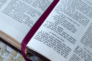 Vision of Jesus Christ verses in open holy bible book. Close-up. Revelation of God, Christian...