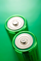 Two green batteries on a green table