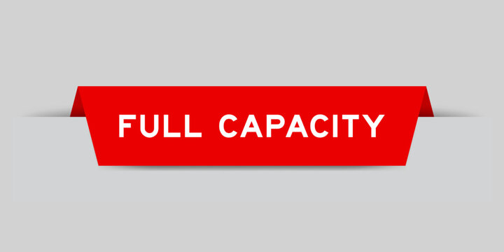 Red color inserted label with word full capacity on gray background