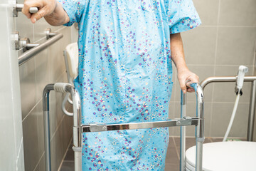 Asian elderly woman patient use toilet bathroom handle security in nursing hospital, healthy strong...