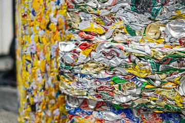 Aluminum cans pressed into large and heavy bales. Recycling and cleaning the environment from household waste. Garbage metal