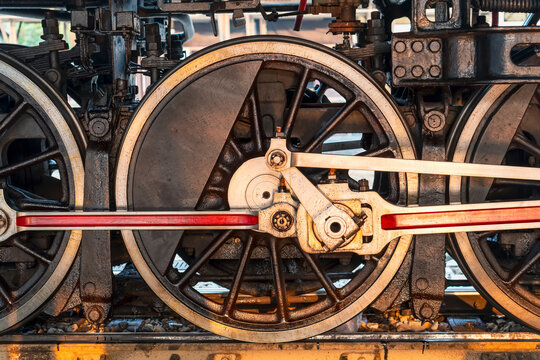 Close-up of red wheels of an old retro steam train locomotive